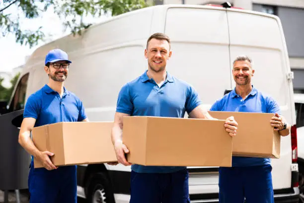Professional movers carefully loading boxes into a moving truck for a stress-free relocation."